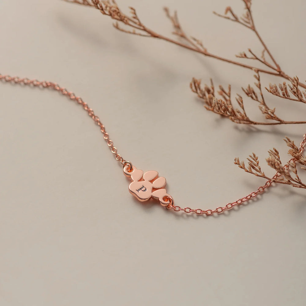 Rose gold paw print bracelet with personalized dog initials