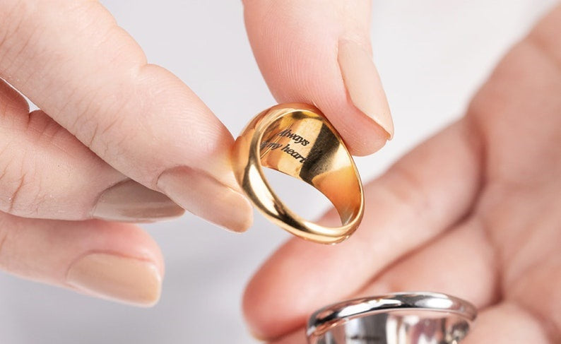 Elegant Custom Pet Jewelry featuring a personalized ring held between two fingers