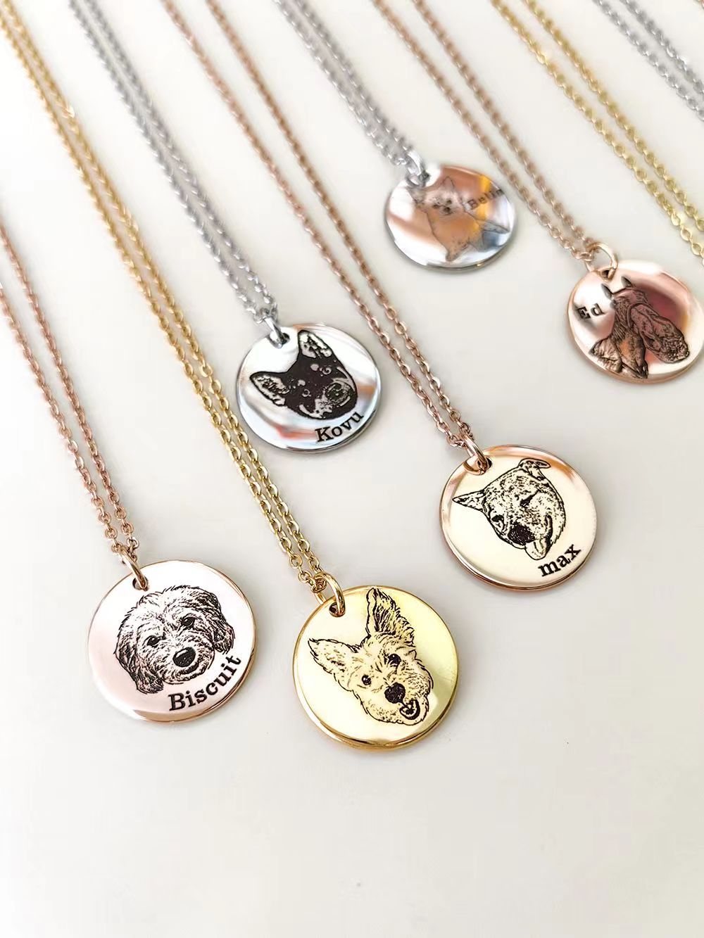Custom Pet Face Necklaces in gold, rose gold and silver showing engraved dog faces and names on round pendants