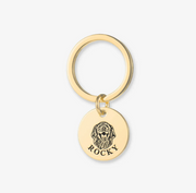 Gold round pet ID key ring showing a detailed dog portrait and name Rocky Pet Face Keychain Deep Engraving