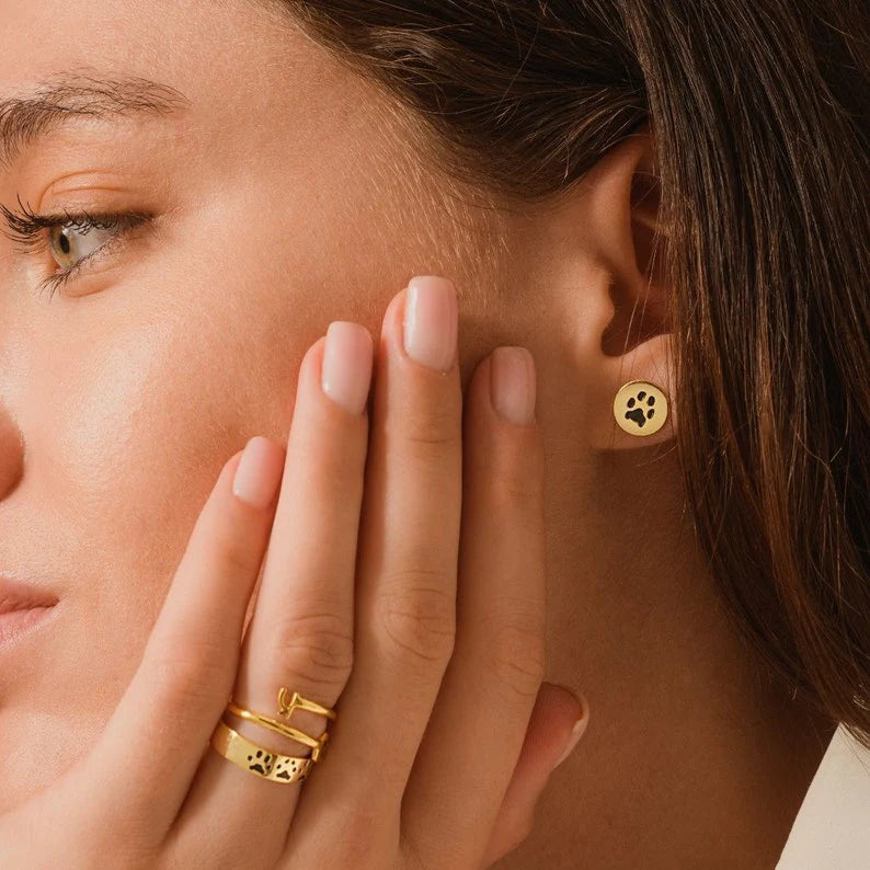 Stylish Pet Paw Earrings showcased on a model, highlighting their unique design and elegance