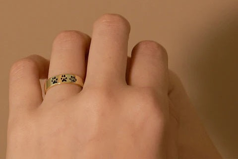 Stylish Personalized Pet Rings featuring paw print designs on a gold band for pet lovers